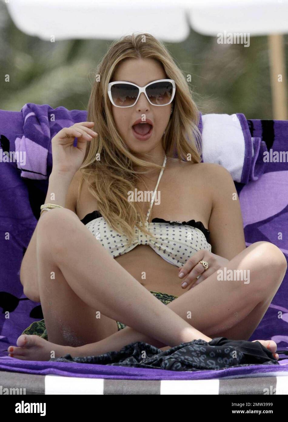 'The City' star Whitney Port films scenes for the show while soaking up the sun and relaxing on Miami Beach with friend, actress Roxy Olin. Port and Olin are in town attending the Mercedes-Benz Fashion Week Swim. Miami Beach, FL. 7/19/09. Stock Photo