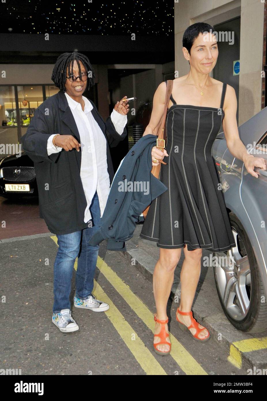 Actress Whoopi Goldberg stops to chat with photographers while smoking a  cigarette outside her London hotel. London, UK. 05/06/11 Stock Photo