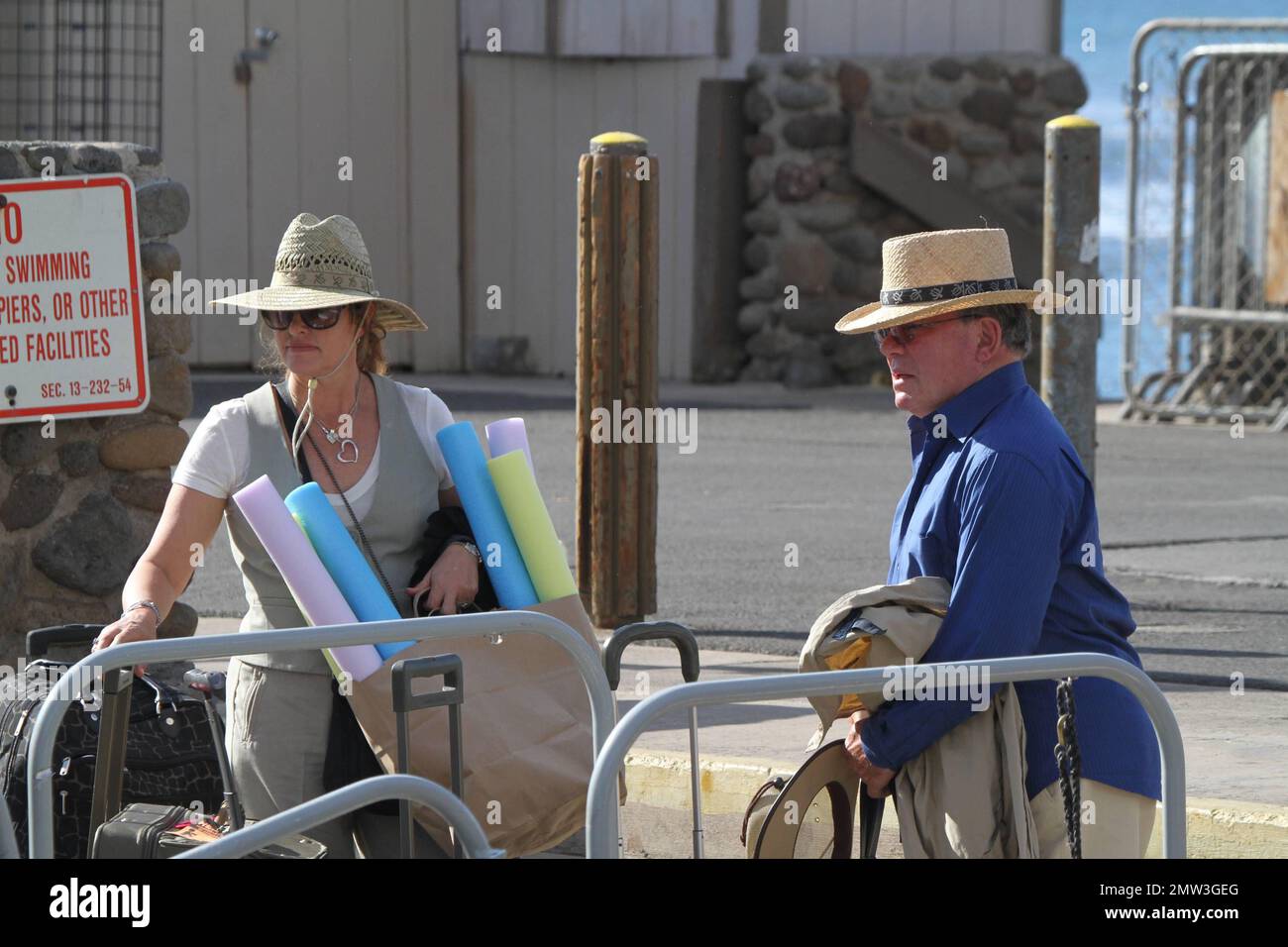 EXCLUSIVE!! Actor William Shatner and wife Elizabeth Martin are seen boarding a boat whilst on holiday in Hawaii.   The star worldly recognized as Captain Kirk of the "Star Trek" series, tried to stay incognito under a Panama hat whilst boarding the boat with luggage and a bag full of water noodles.  Shatner, 80, is reportedly headed to Broadway again.  His one man show, "Shatner's World: We Just Live In It" will debut in February 2012 for a brief run at the Music Box Theatre on Broadway. The show which Shatner wrote himself, will kick off a 15-week national tour and is based on the years of f Stock Photo