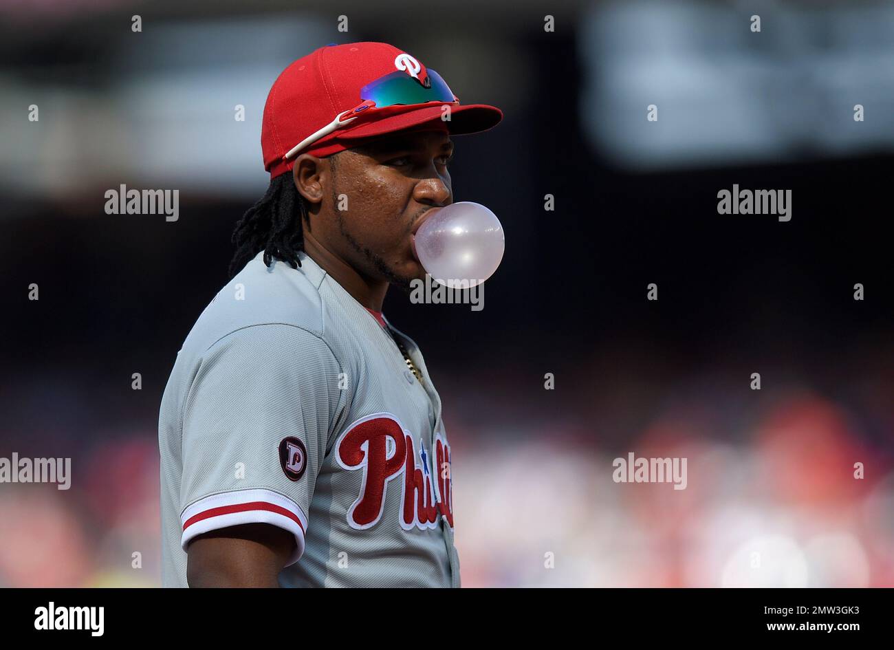 Philadelphia Phillies third baseman Maikel Franco blows a bubble during the second inning of a baseball game against the Washington Nationals, Friday, April 14, 2017, in Washington. (AP Photo/Nick Wass) Stock Photo
