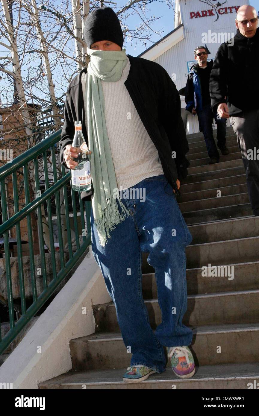 Exclusive!! Woody Harrelson hangs out with Ben Foster while Ben smokes a  cigarette. Later, Woody heads out for a stroll and covers up from  photographers using his scarf during the Sundance Film