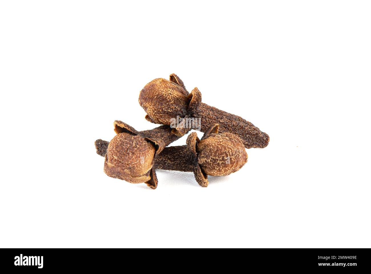 Three sprigs of dry spice cloves on a white background. Clove a spice