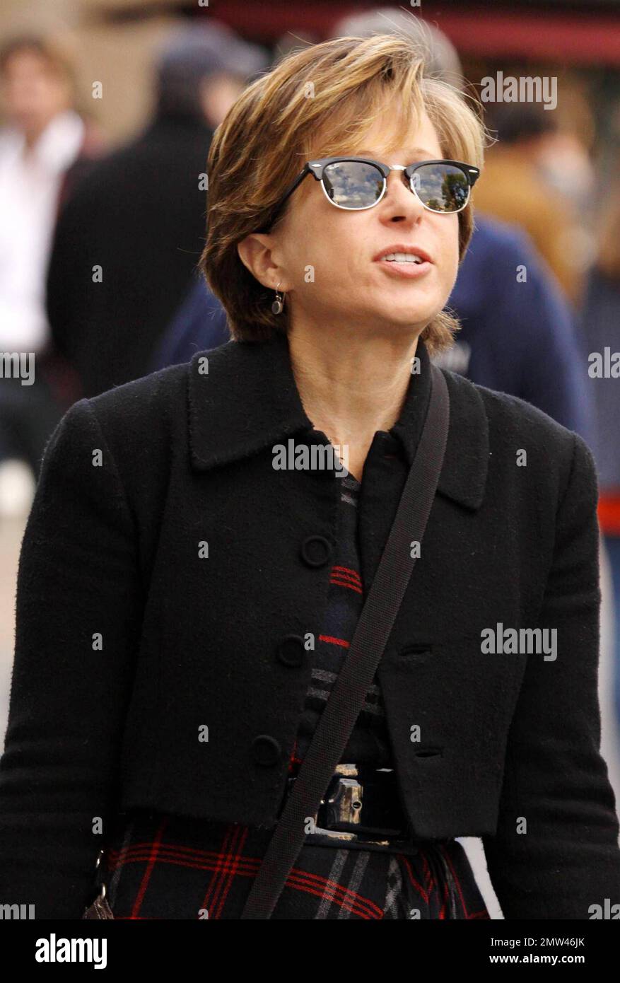 EXCLUSIVE!! Actress Yeardley Smith, voice of Lisa Simpson on the long running TV series 'The Simpsons', wears trendy horn-rimmed sunglasses and a plaid skirt at The Grove where she walked with a friend and appeared a bit shy.  Yeardley is currently working on the 22nd season of 'The Simpsons'. Los Angeles, CA. 11/24/10. Stock Photo