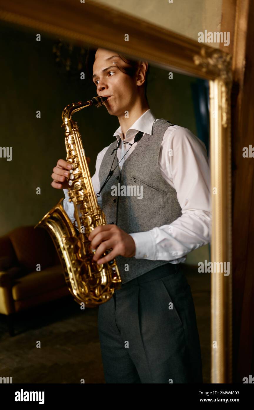 Young Man Plays Mini Saxophone with Bare Hands Stock Photo - Image