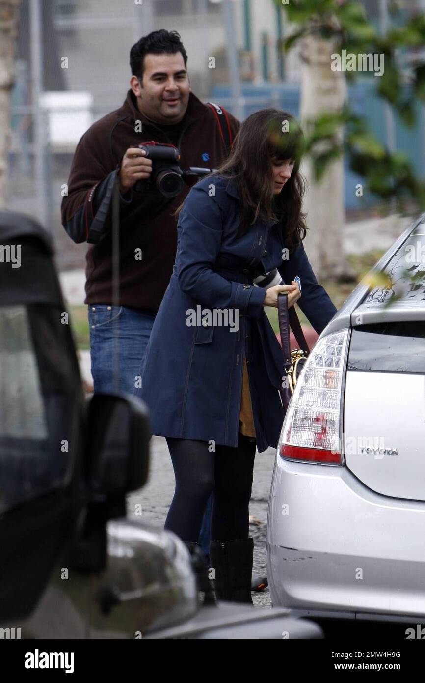 Actress Zooey Deschanel looks a bit annoyed while being closely