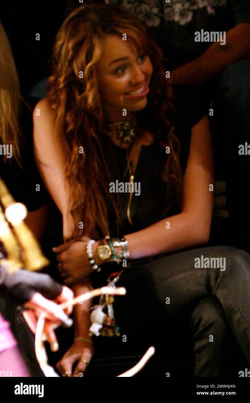 Mylie Cyrus has a great time with her mom and friends watching her