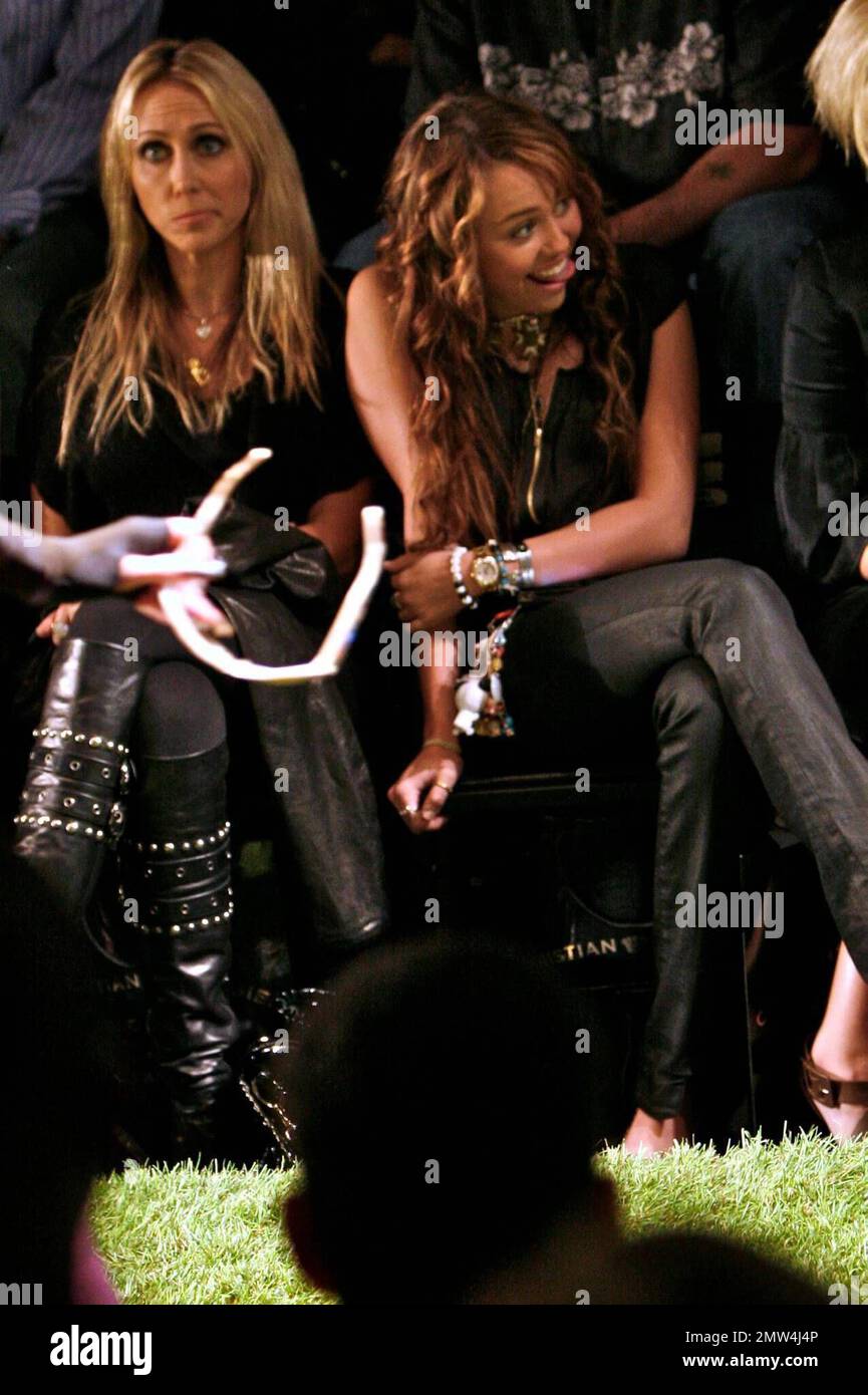 Mylie Cyrus has a great time with her mom and friends watching her