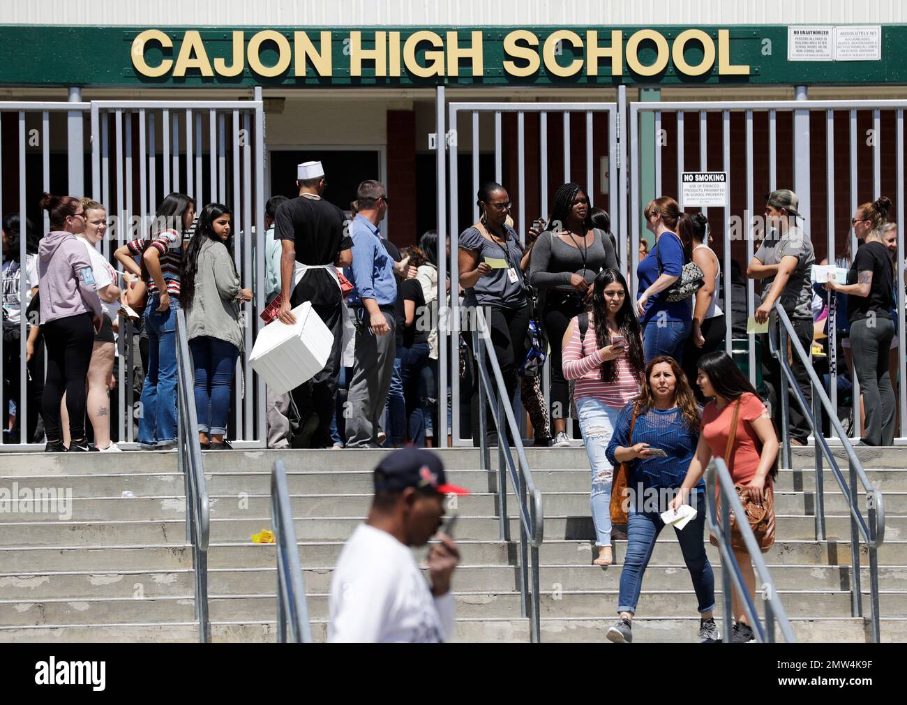 Parents and guardians of North Park Elementary School students wait at