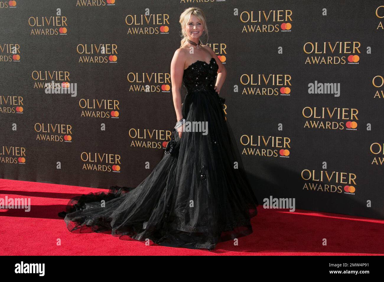 Carley Stenson poses for photographers as she arrives for the Olivier