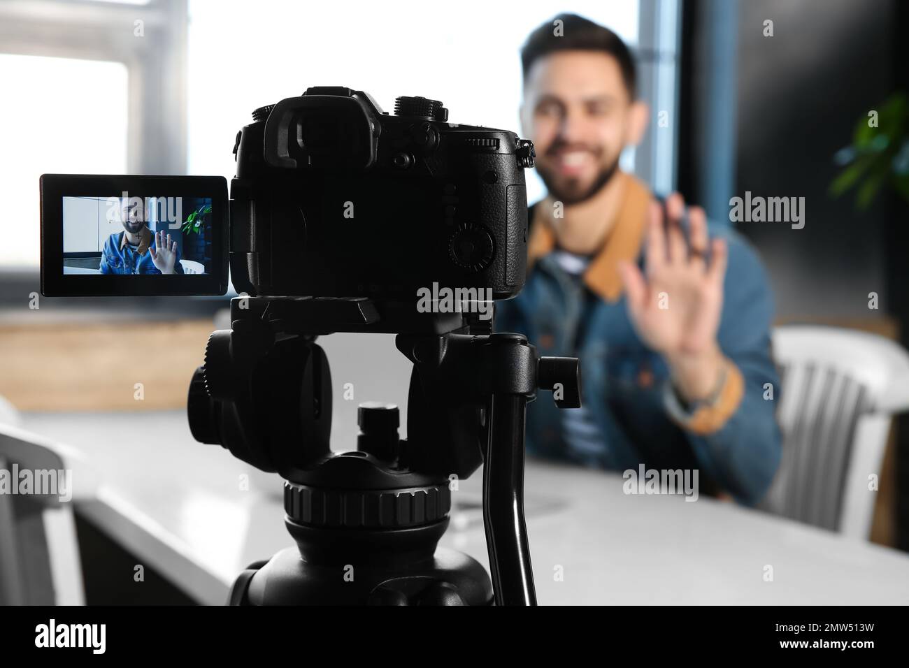 Young blogger recording video at cafe, focus on camera screen Stock Photo -  Alamy