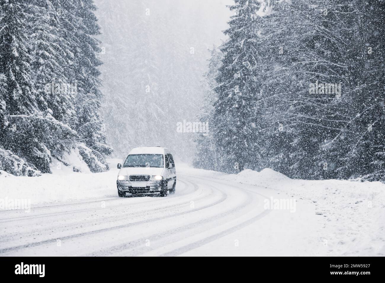 Snowy country road with modern car on winter day Stock Photo - Alamy