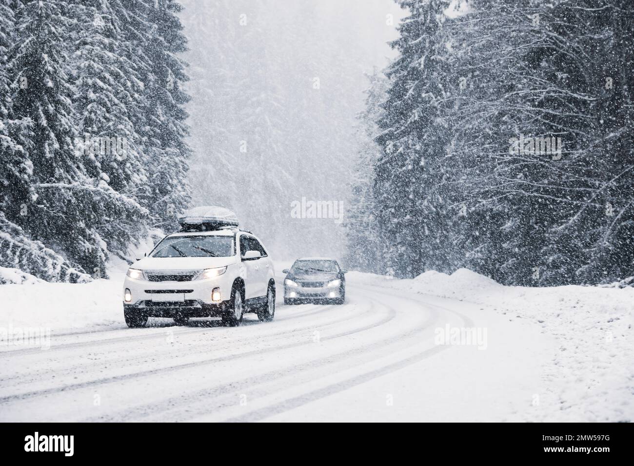 Snowy country road with modern cars on winter day Stock Photo - Alamy