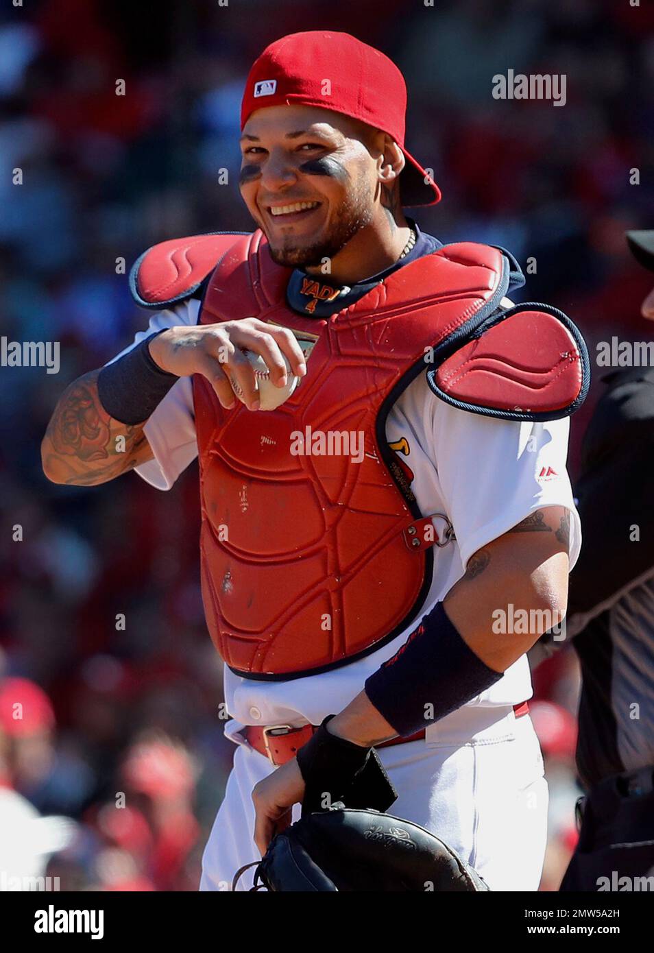 St. Louis Cardinals catcher Yadier Molina laughs after a ball somehow