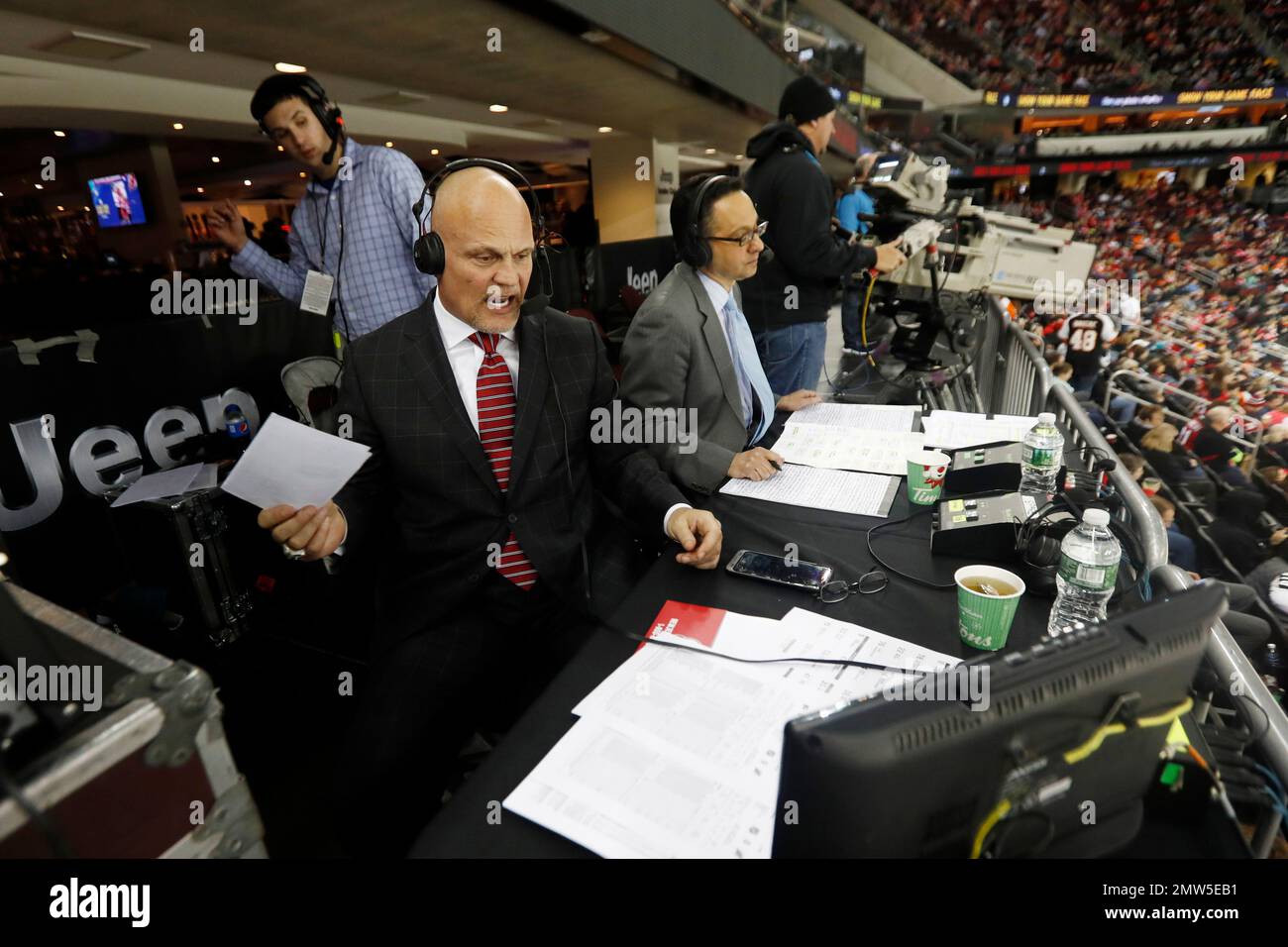 New Jersey Devils television announcers Ken Daneyko, center, and Steve