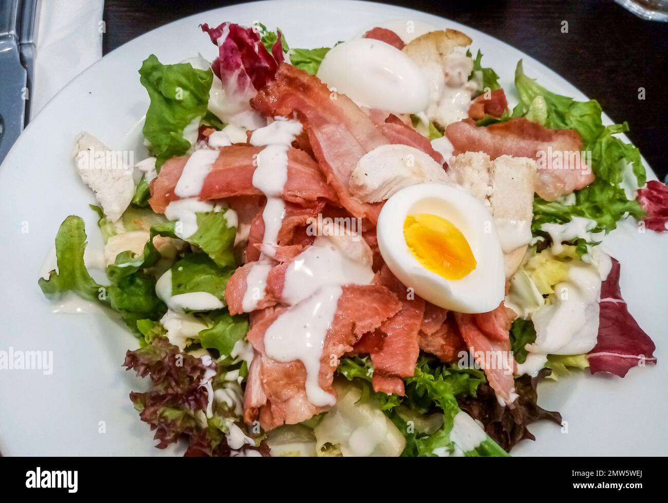 Caesar salad with crispy bacon, chicken and boiled egg Stock Photo Alamy