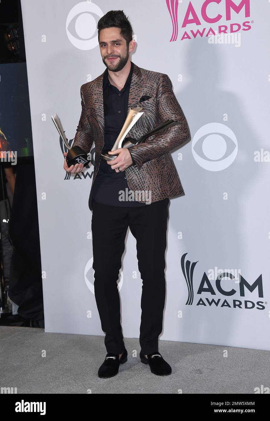 Thomas Rhett poses in the press room with his awards for artist and ...