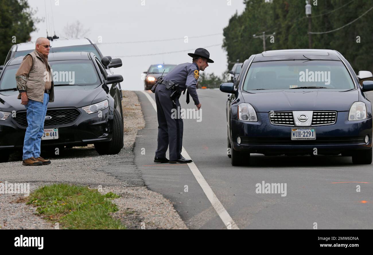 State police and investigators look over the spot where two children were killed when they ran