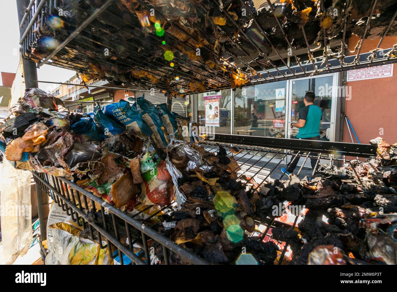 A rack with burned merchandise pulled from a blaze is seen at a Los ...