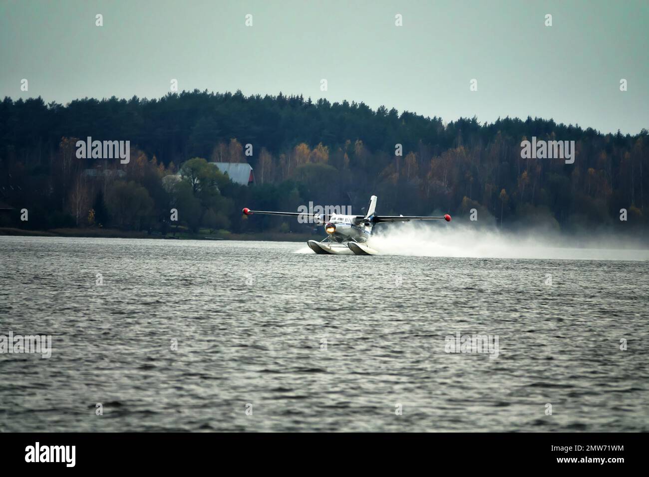 The Twinengine seaplane a seaplane rises from water, from the forest