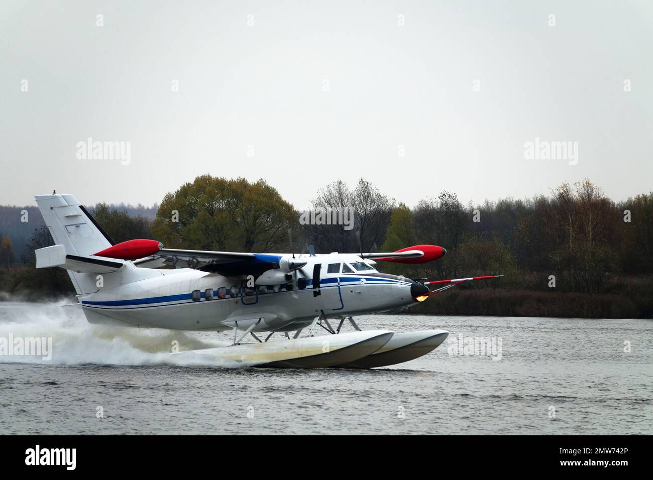 The Twinengine seaplane a seaplane rises from water, from the forest