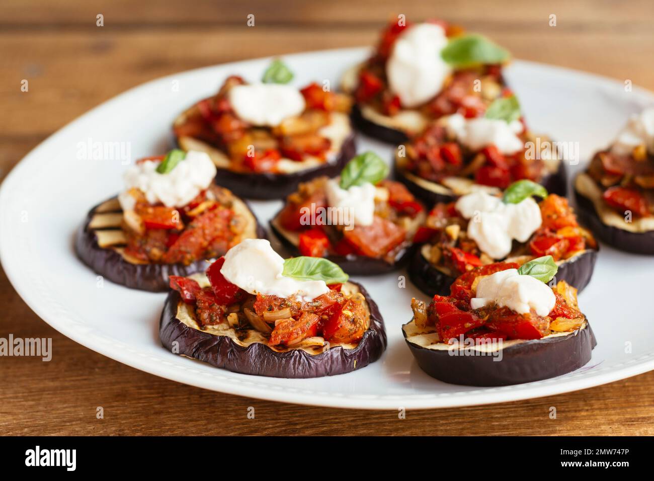 Grilled eggplant with a tomato and bell pepper Sauce, garnished with