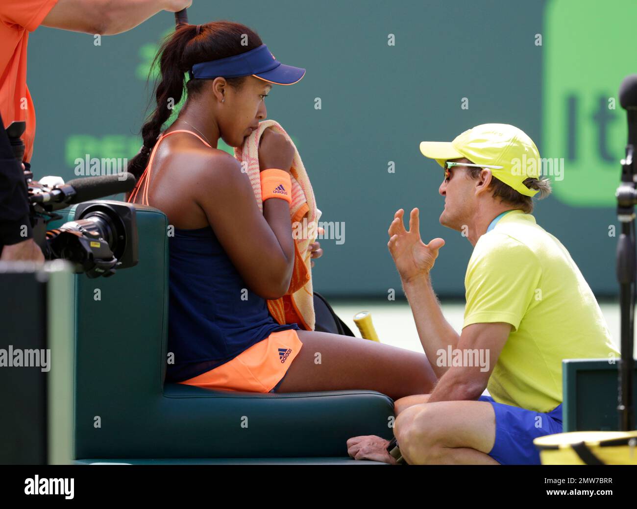 Naomi Osaka, of Japan, left, talks with her coach David Taylor, right,  during her match against Simona Halep at the Miami Open tennis tournament,  Friday, March 24, 2017, in Key Biscayne, Fla. (