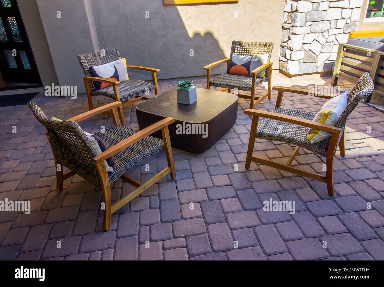 Front Home Patio Area With Four Wooden Chairs Stock Photo - Alamy