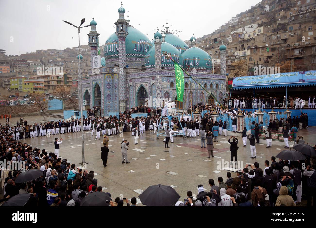 Men rise "Jahenda" flag, an Islamic flag, during celebrations of Nowruz, the Persian new year