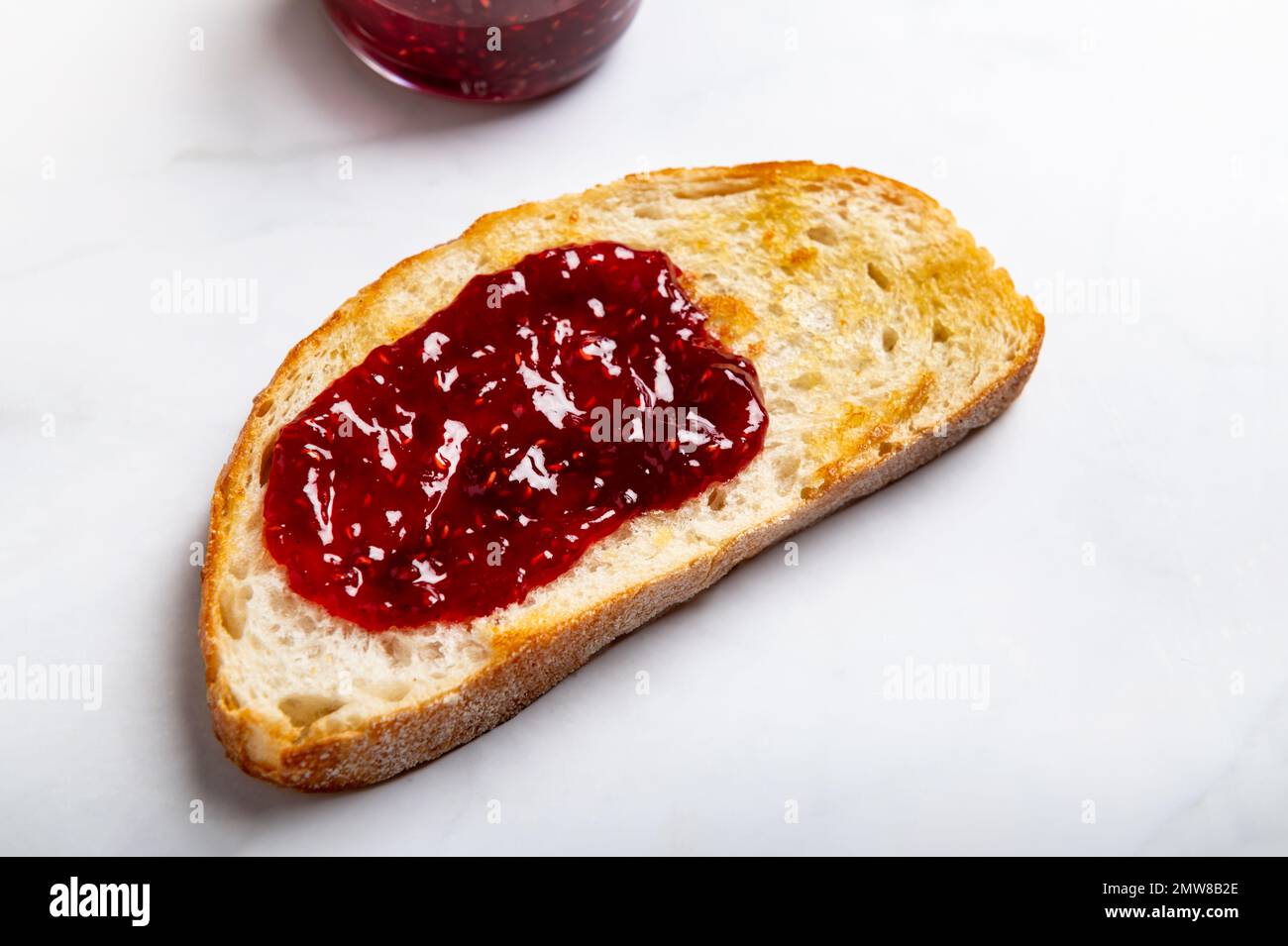 Raspberry jam on toast Stock Photo Alamy