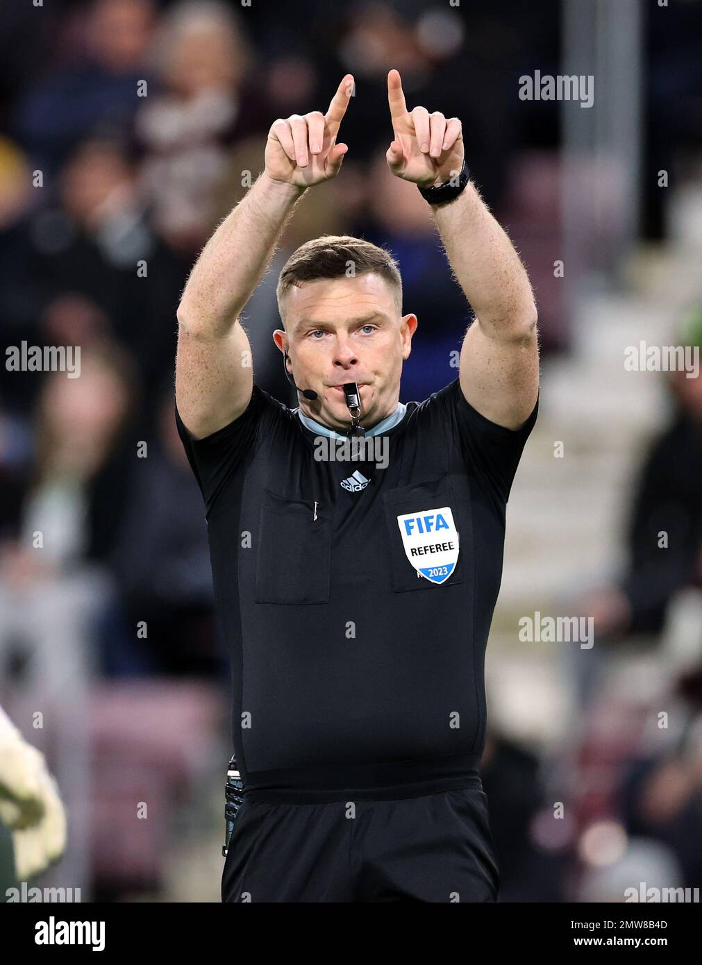 Referee John Beaton signals for a VAR decision during the cinch