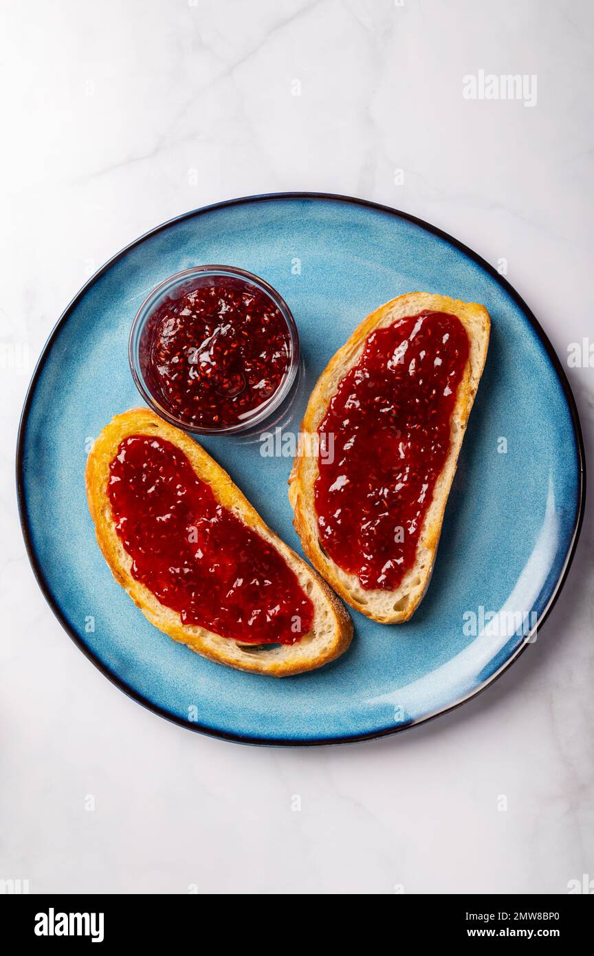 Raspberry jam on toast Stock Photo Alamy