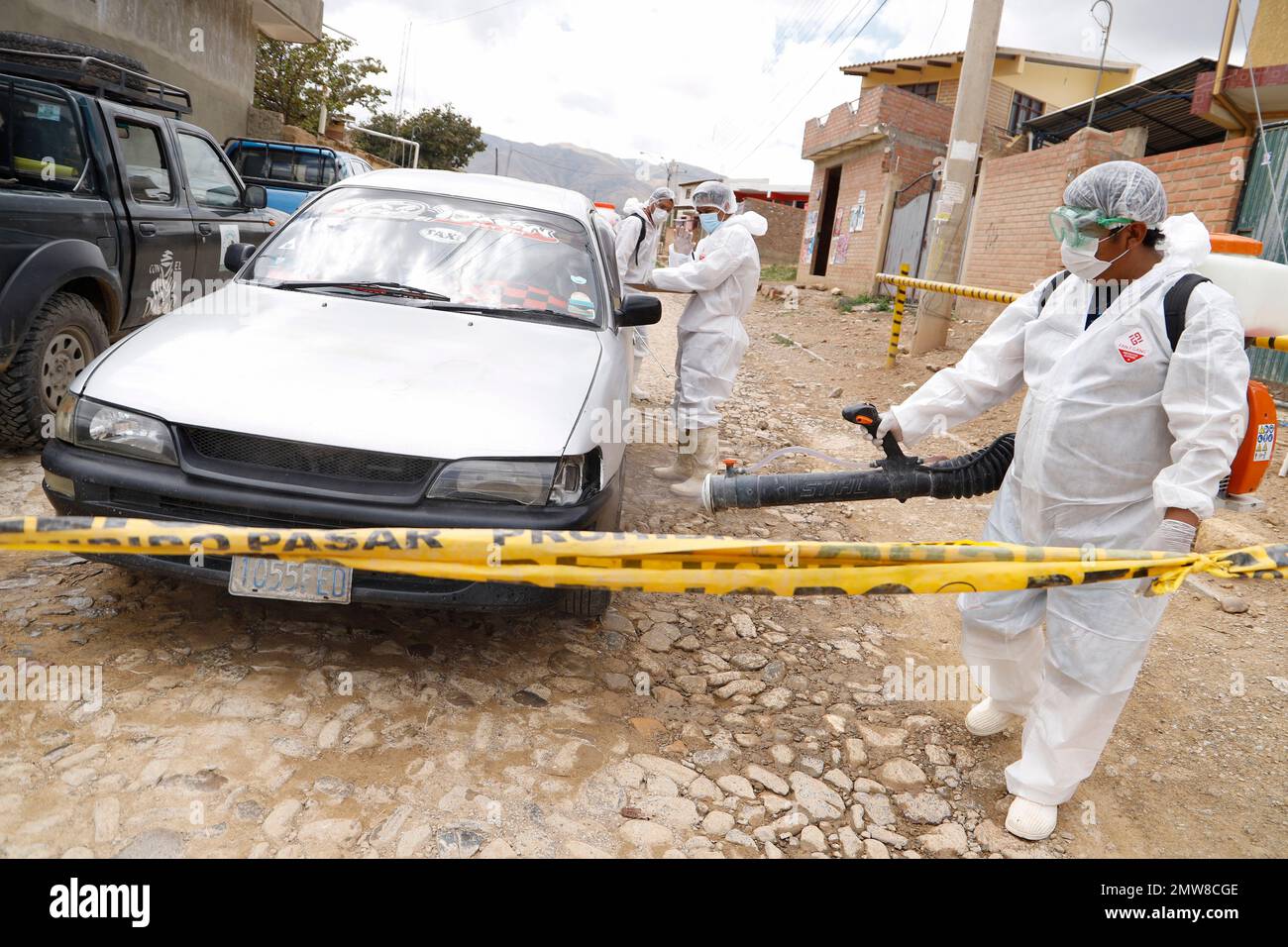 Cochabamba, Bolivia. 01st Feb, 2023. A health worker in protective gear disinfects a car near a site where an avian flu outbreak has been detected. Credit: David Flores/dpa/Alamy Live News Stock Photo
