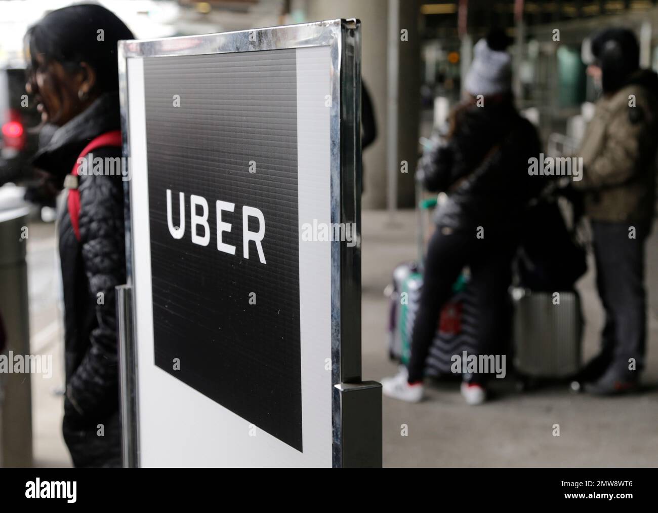 A sign marks a pick-up point for the Uber car service at LaGuardia ...