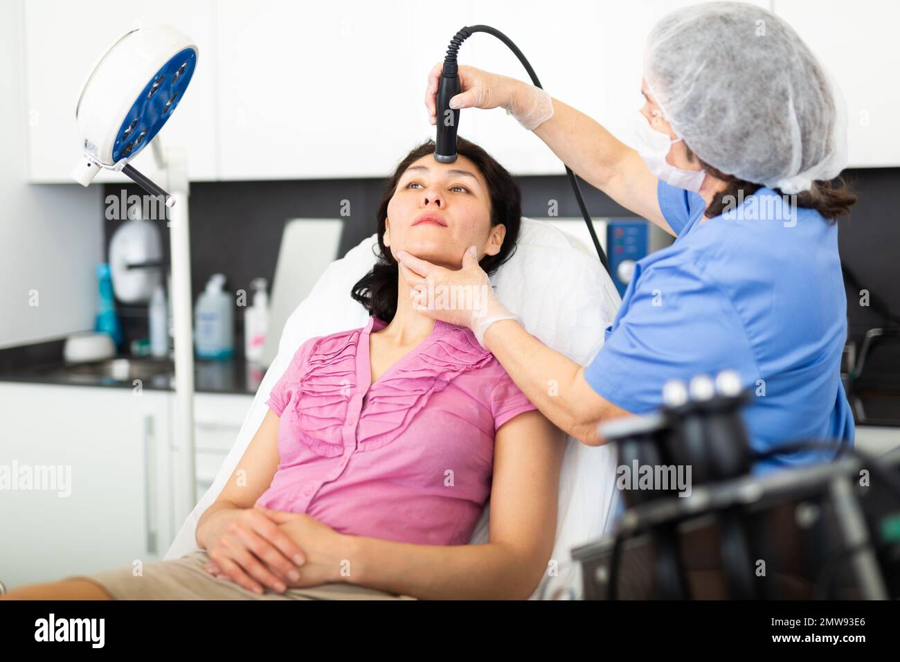 Female receiving hardware facial mesotherapy at clinic Stock Photo - Alamy