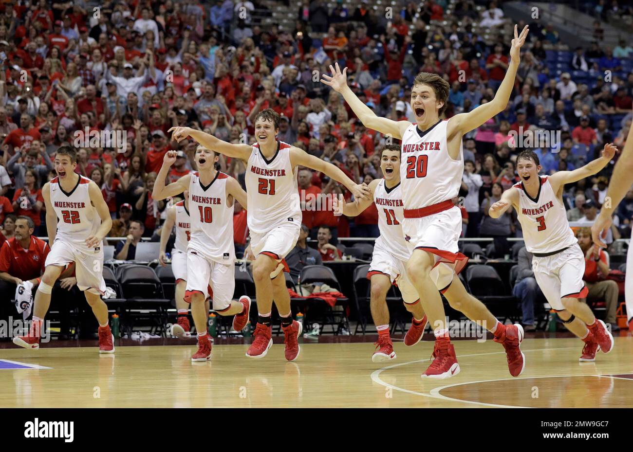 Muenster's John Weger (20) and teammates celebrate their win over