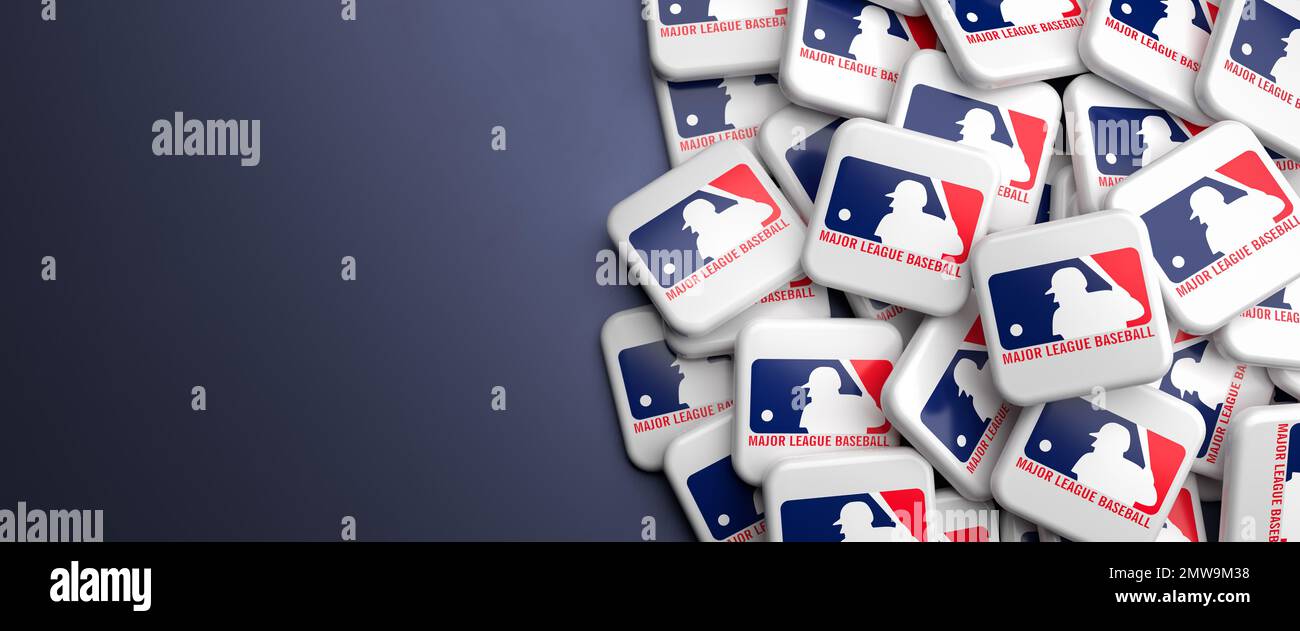 Logos of the American Baseball League MLB (Major League Baseball) on a heap on a table. Stock Photo