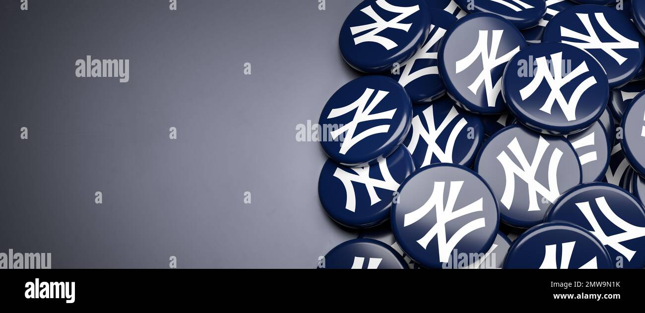 Logos of the American Major League Baseball Team New York Yankees on a heap on a table Stock