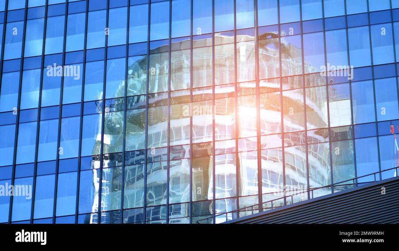 Abstract closeup of the glass-clad facade of a modern building covered ...