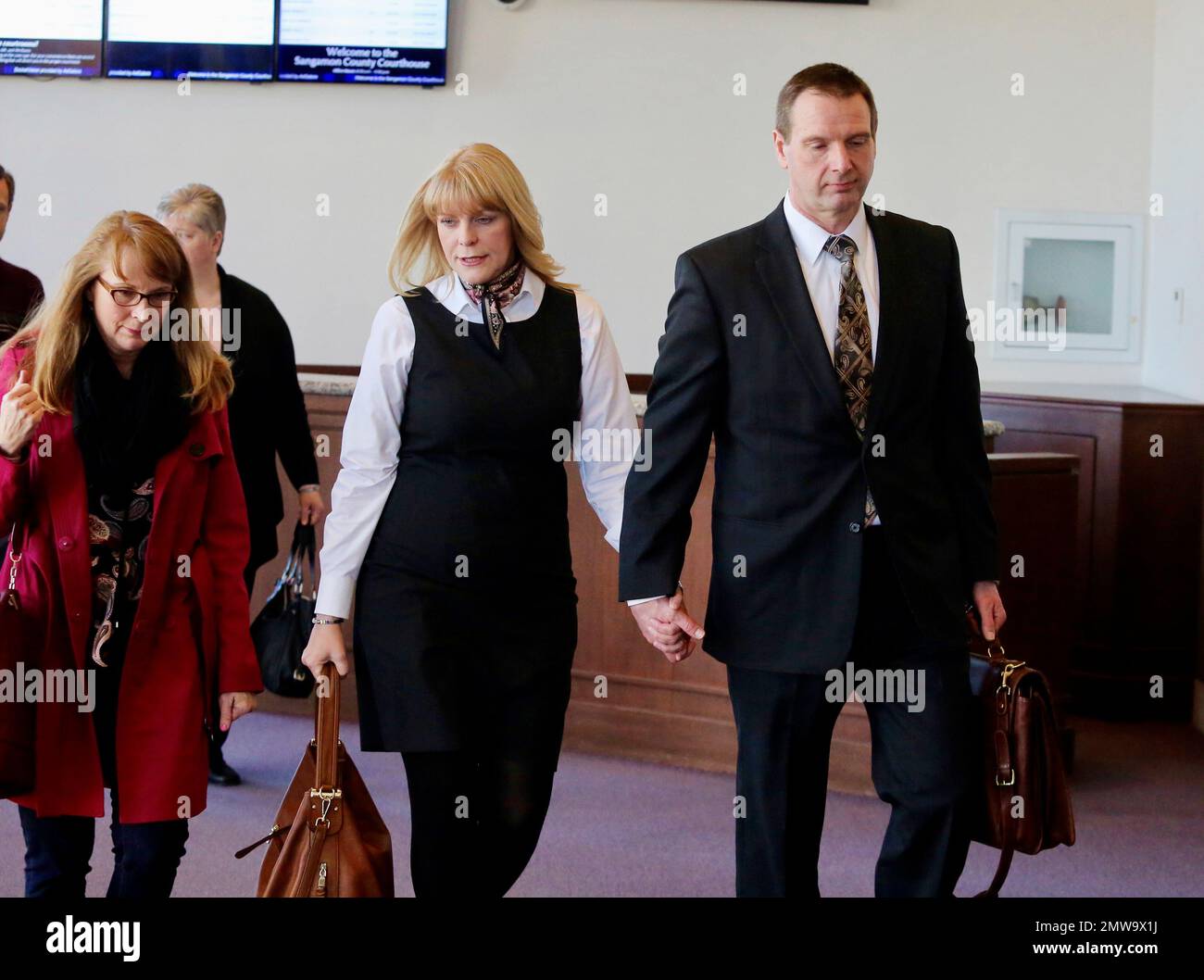 Curtis Lovelace walks with his wife, Christine, to the courtroom where