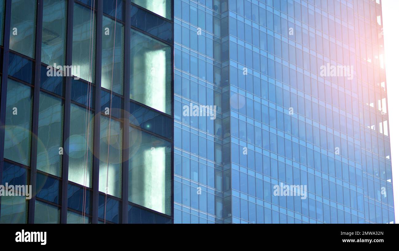 Abstract closeup of the glass-clad facade of a modern building covered ...