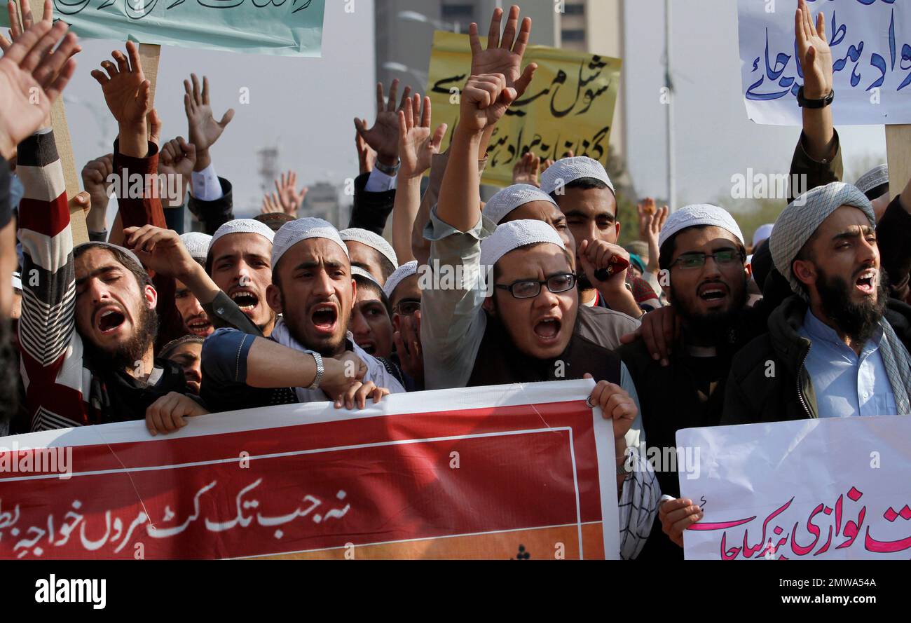 Pakistani students of Islamic seminaries chant slogans during a rally ...