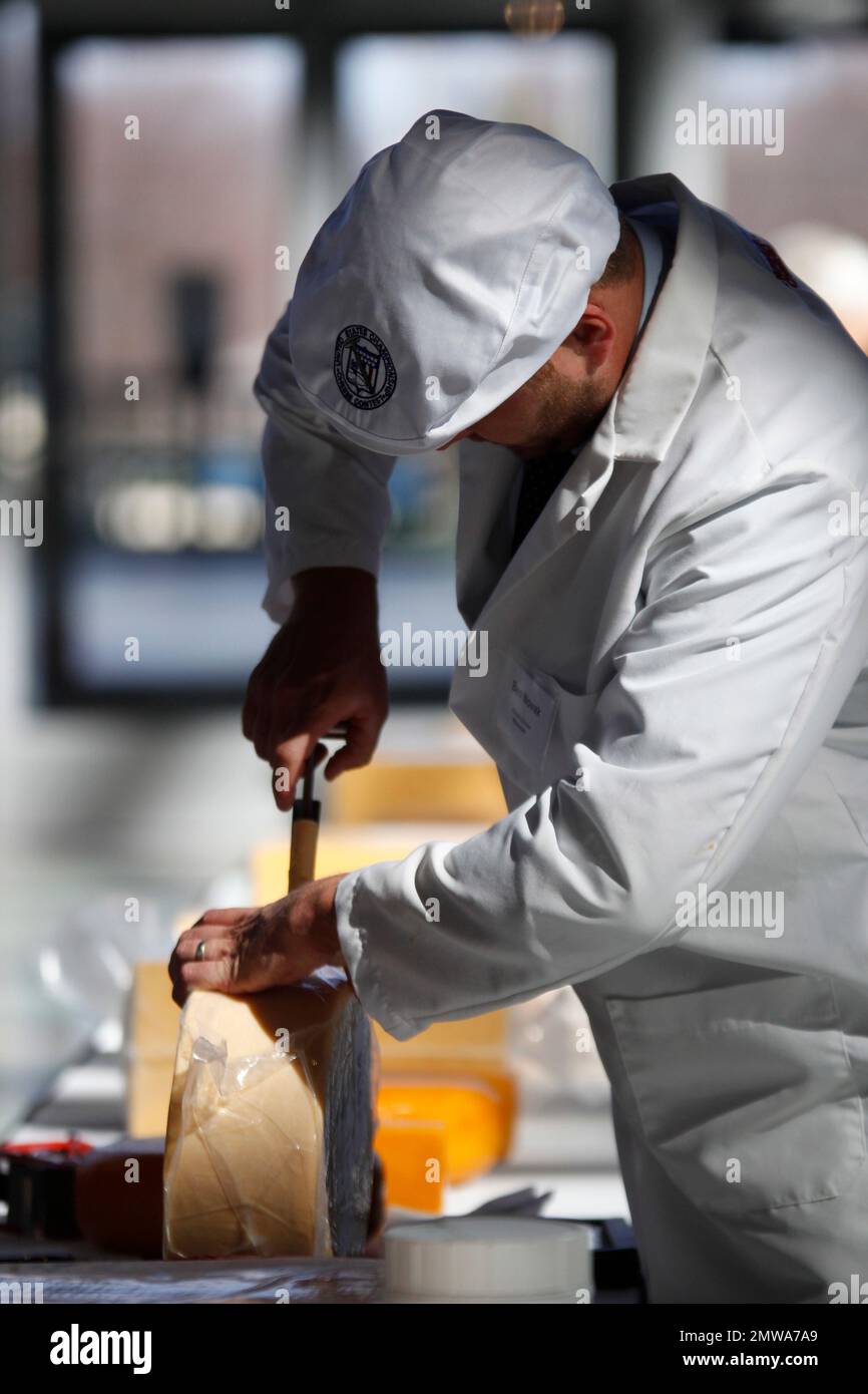 judge Ben Novak cuts into a cheese at the U.S. Championship Cheese