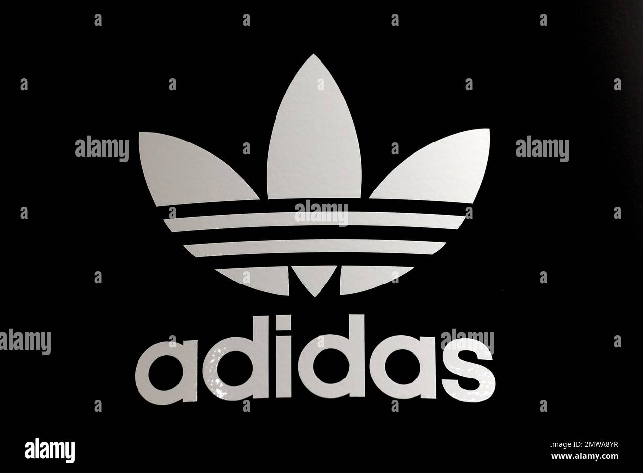 Adidas logo on a wall. Adidas is a German multinational that manufactures  sports shoes, clothing Stock Photo - Alamy