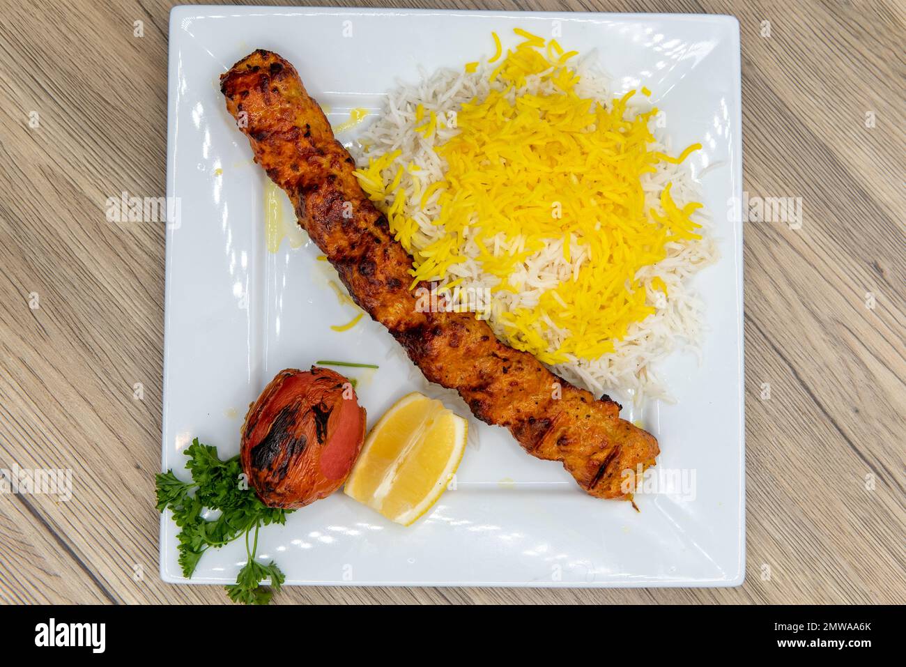 Overhead view of generous skewer of koobideh chicken, grilled to perfection and seasoned served with basmati rice. Stock Photo