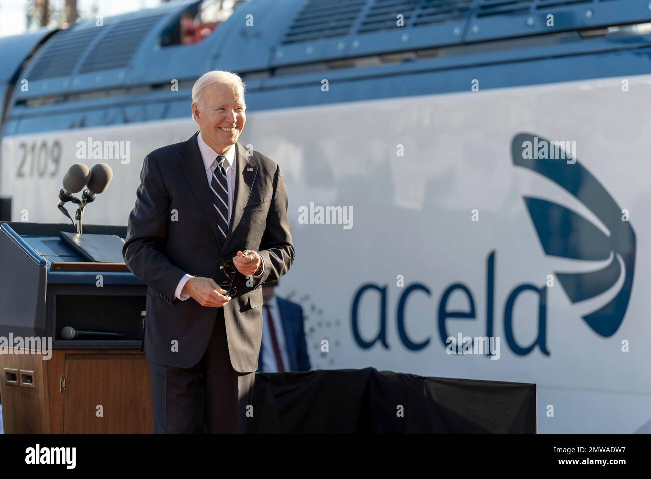 Baltimore, United States of America. 30 January, 2023. U.S President Joe Biden stands next to an Acela train during an event announcing the replacement of the 150-year-old Baltimore and Potomac Tunnel at the Falls Road Amtrak maintenance building, January 30, 2023 in Baltimore, Maryland.  Credit: Adam Schultz/White House Photo/Alamy Live News Stock Photo