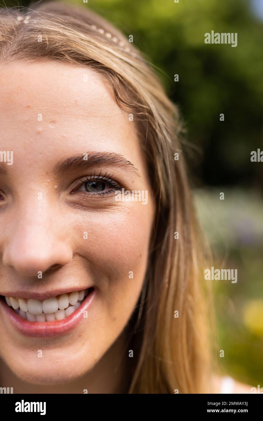 Vertical close up portrait of caucasian bride with green eyes in garden at outdoor wedding Stock Photo