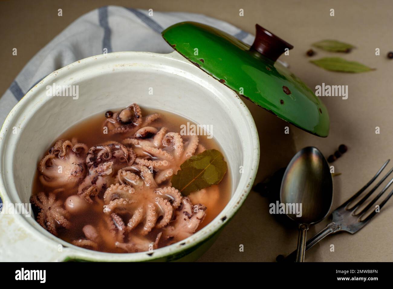 Boiled octopus is in the casserole. Pulpo a la Gallega (Galician-style octopus) is a typical dish from Galicia. Stock Photo