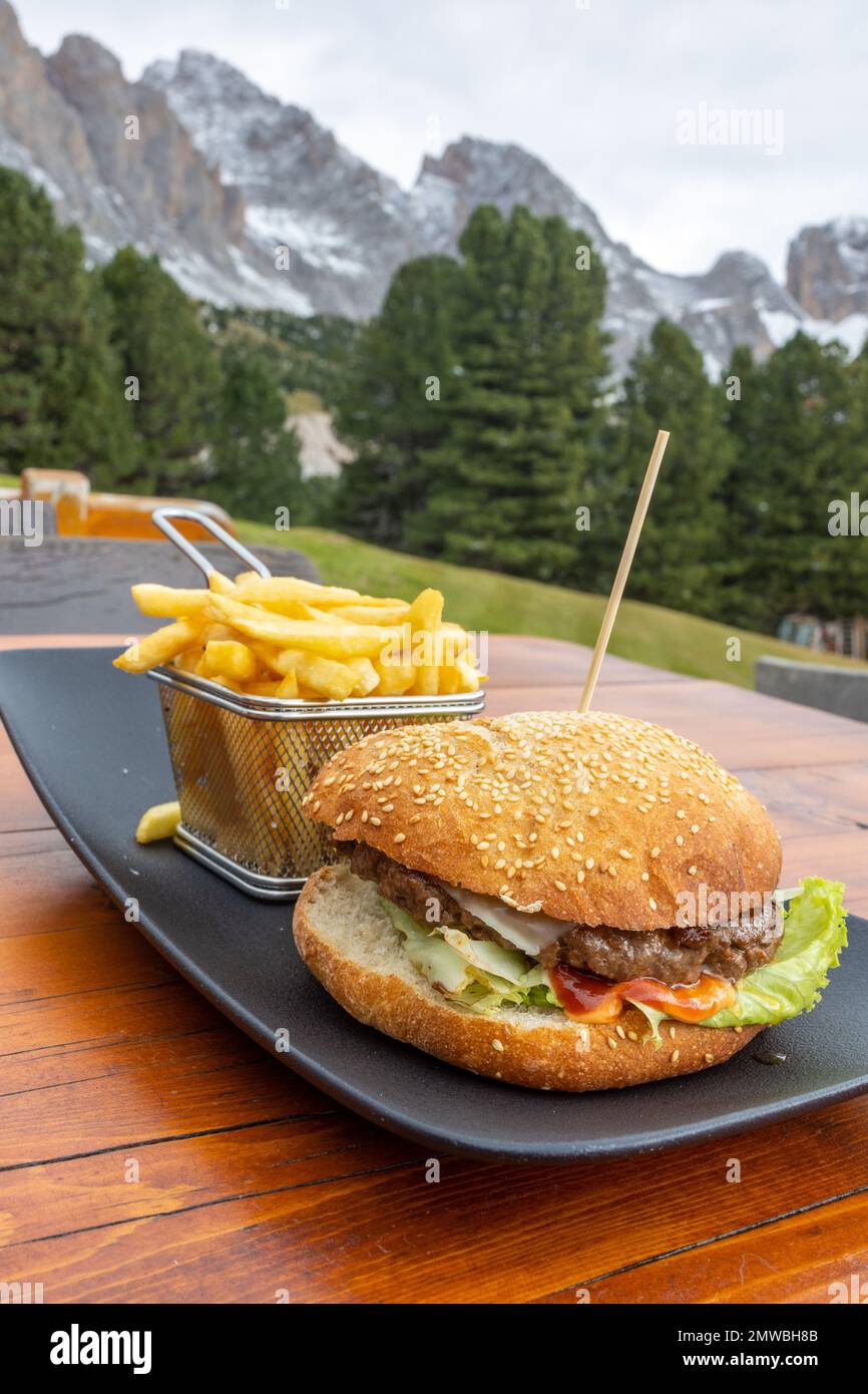 fresh burger and fries on outdoor restaurant terrace table Stock Photo