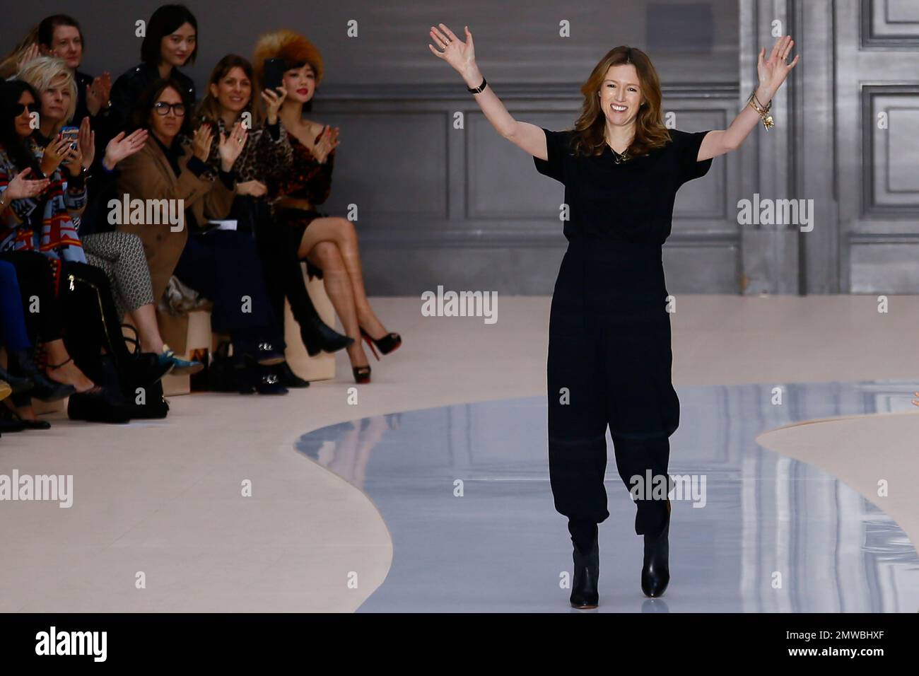 Fashion designer Clare Waight Keller acknowledges applause at the end of the presentation of Chloe s Fall Winter 2017 2018 ready to wear fashion collection presented in Paris Thursday March 2 2017. AP...