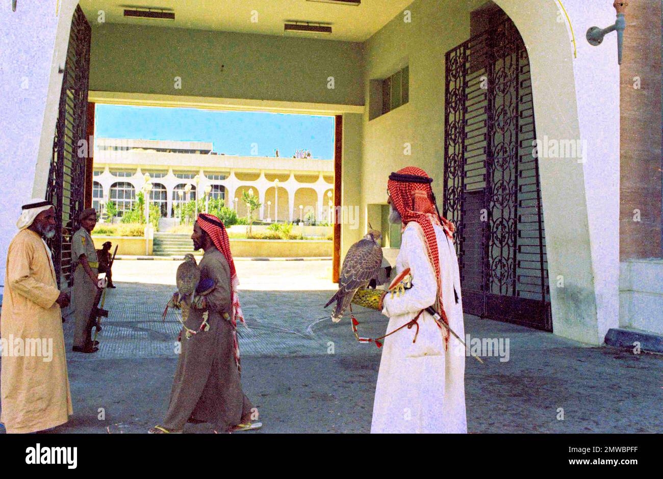 Bedouin falconers are pictured at the entrance to the palace of Sheikh